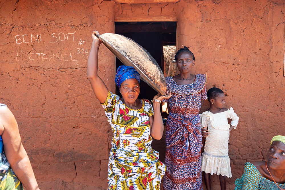 Adjoa carrying a bowl on her shoulder after cleft surgery