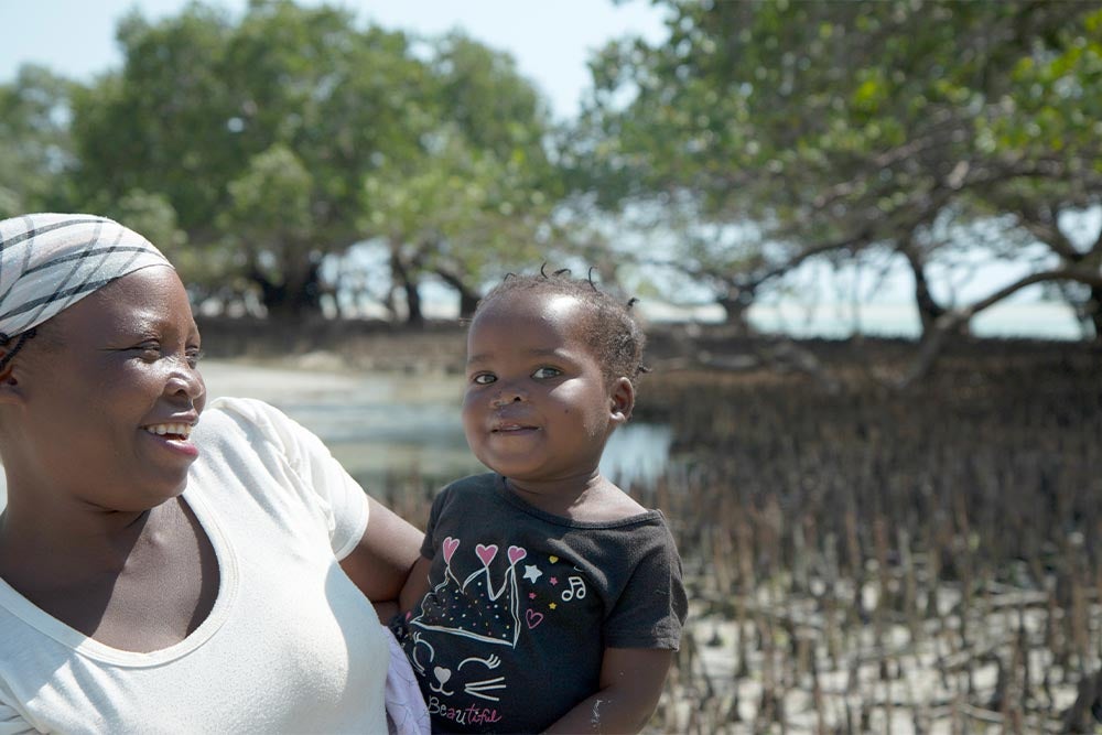 Anabela smiling and holding Zena after her cleft surgery