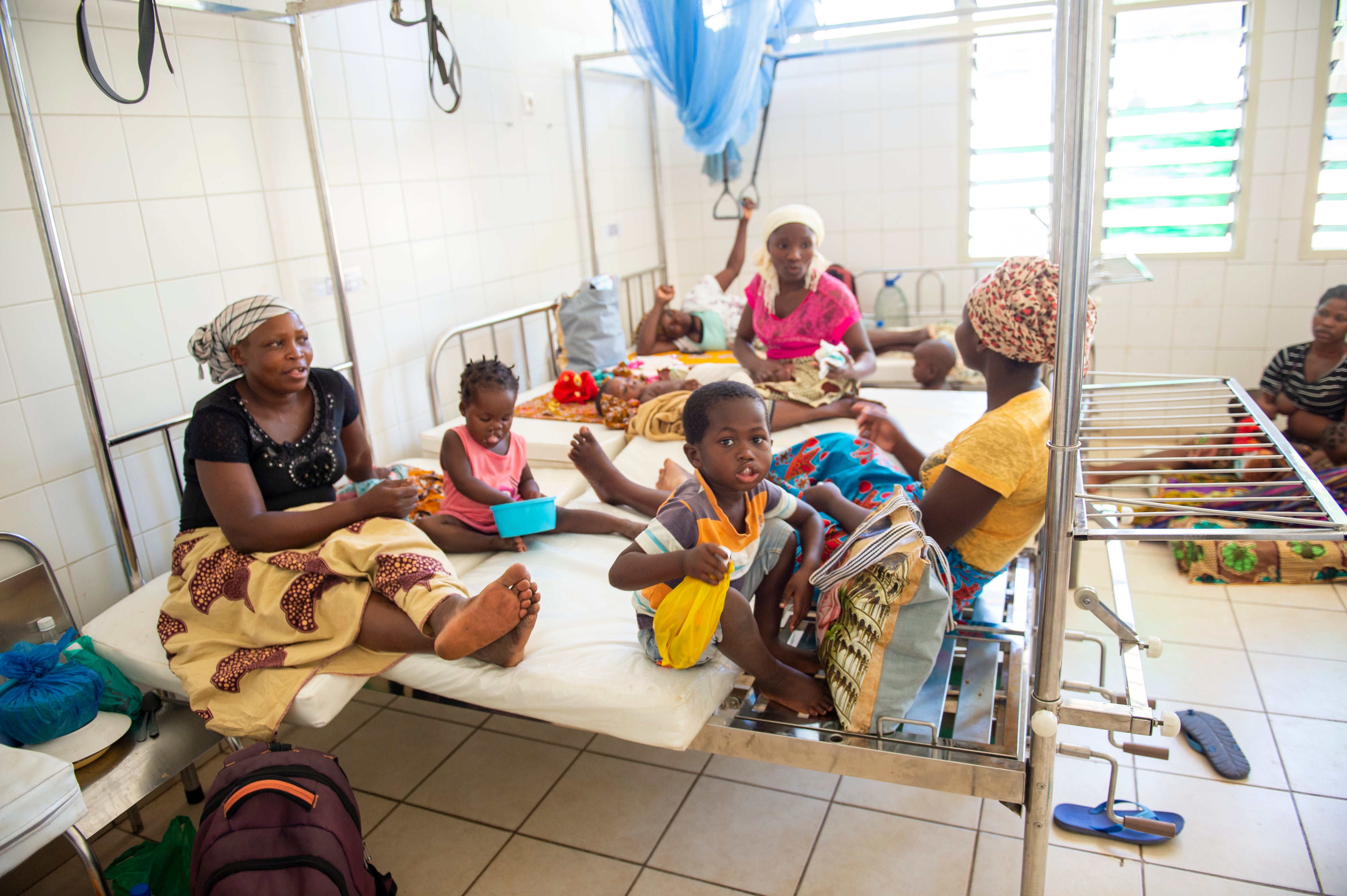 Anabela and Zena waiting in the waiting room with other patients before cleft surgery