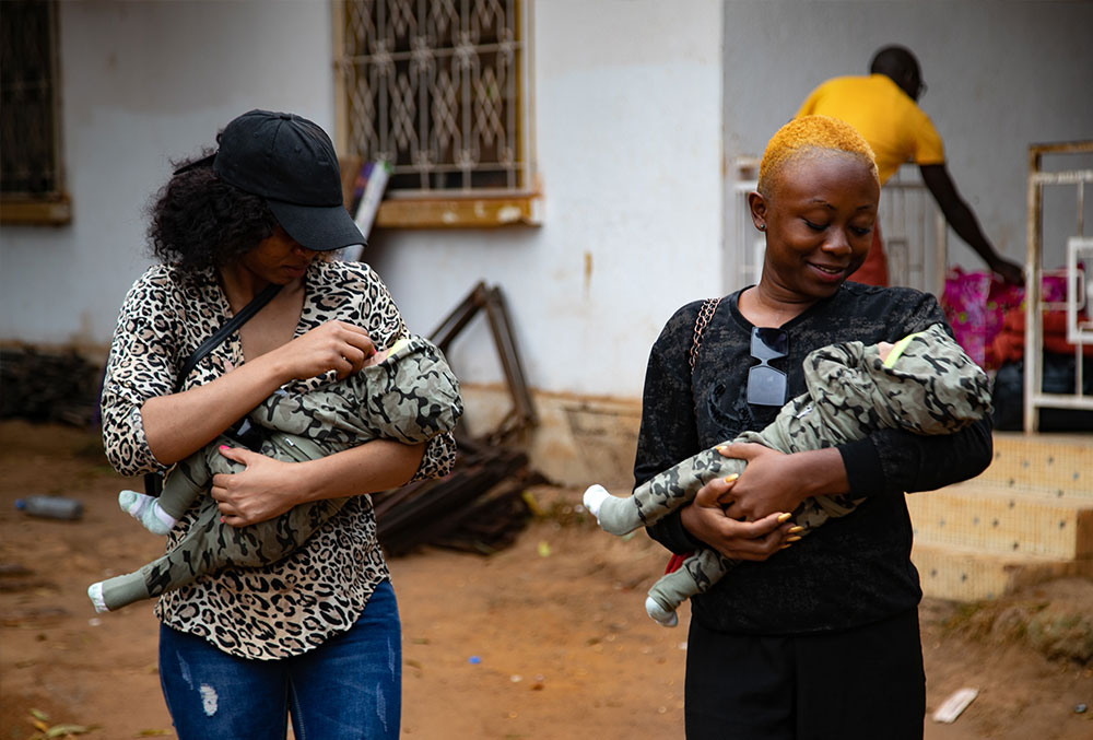 Audrey and Fabiola carrying Lloyd and Floyd before their cleft surgeries