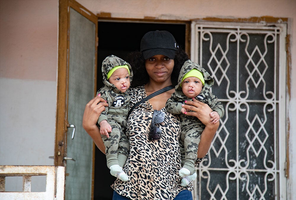 Audrey holding Lloyd and Floyd before their cleft surgeries