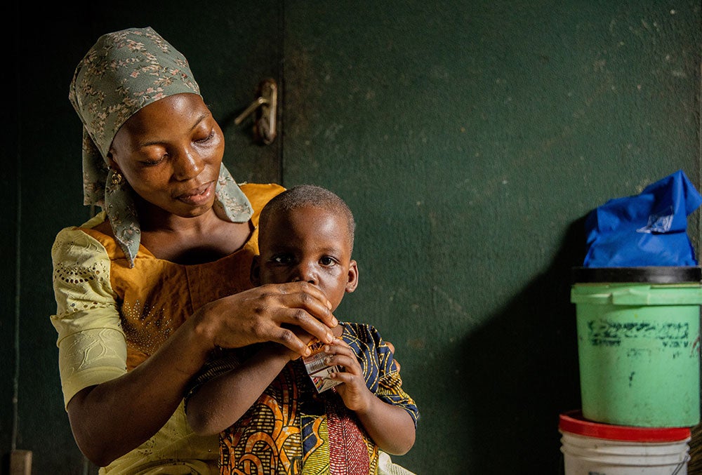 Deborah feeding Opeyemi juice before cleft surgery