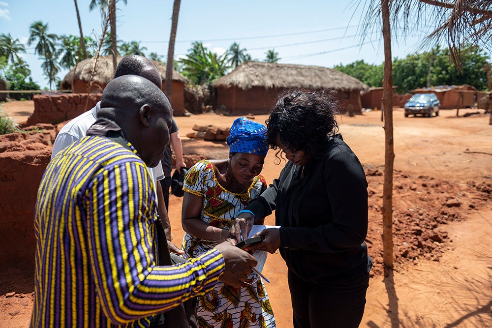 Dr. Nina Capo-Chichi consulting with a Smile Train patient's family