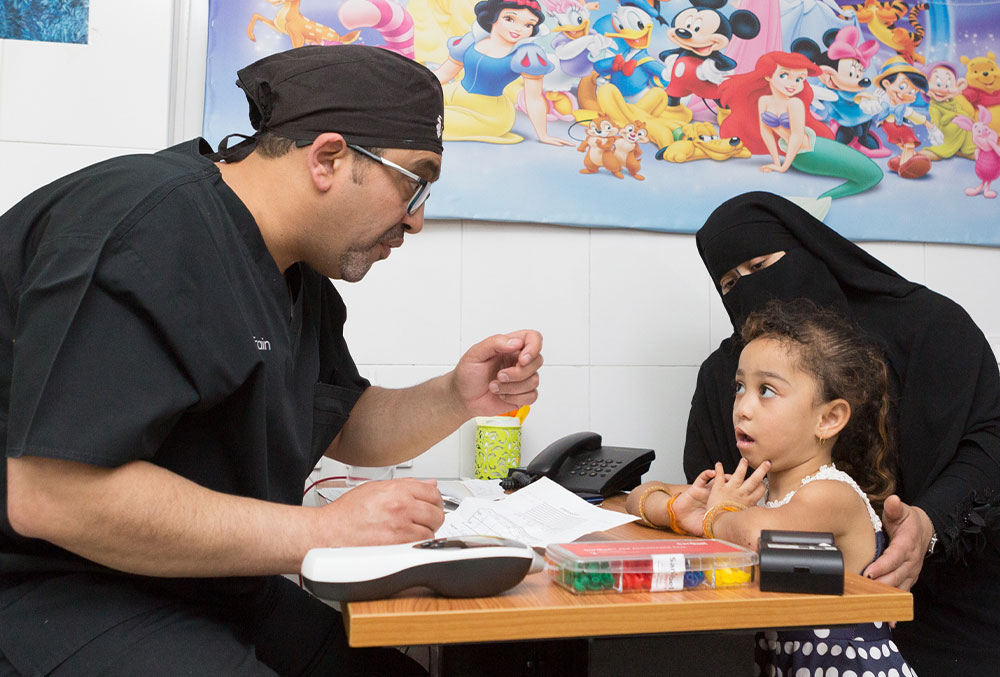 Dr. Tarek giving a cleft affected patient and her mother a consultation