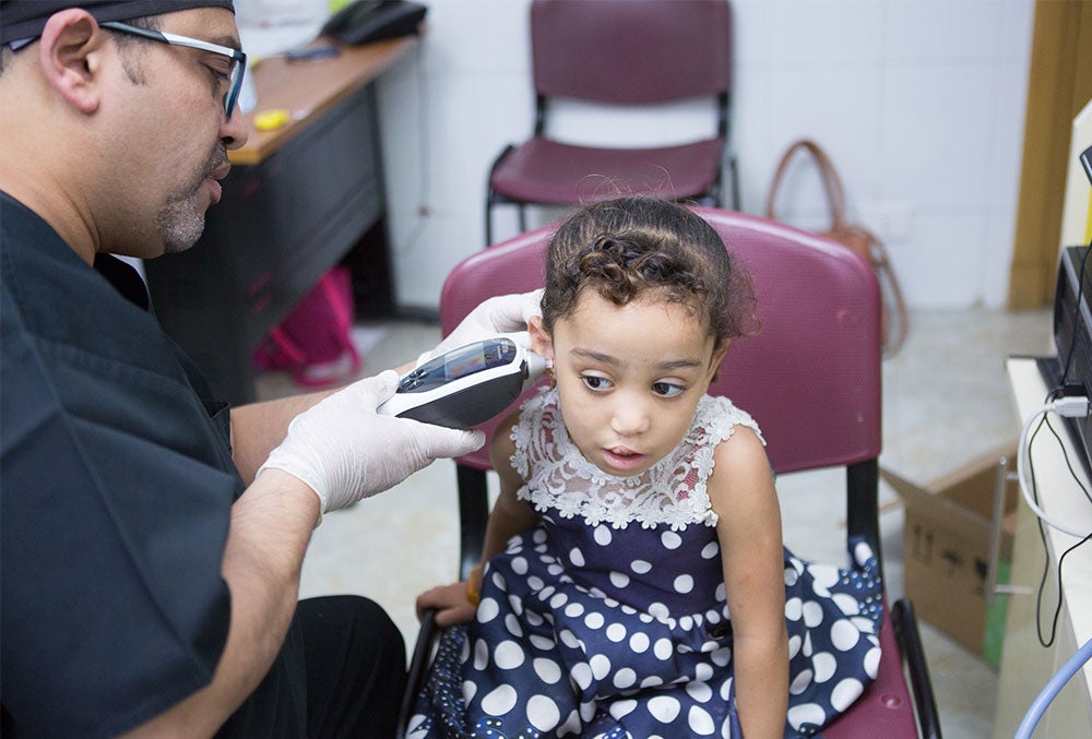 Dr. Tarek testing a cleft-affected patient's hearing