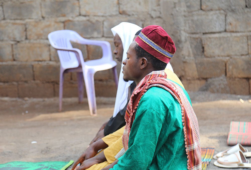 Mouhamed's father Amissou praying