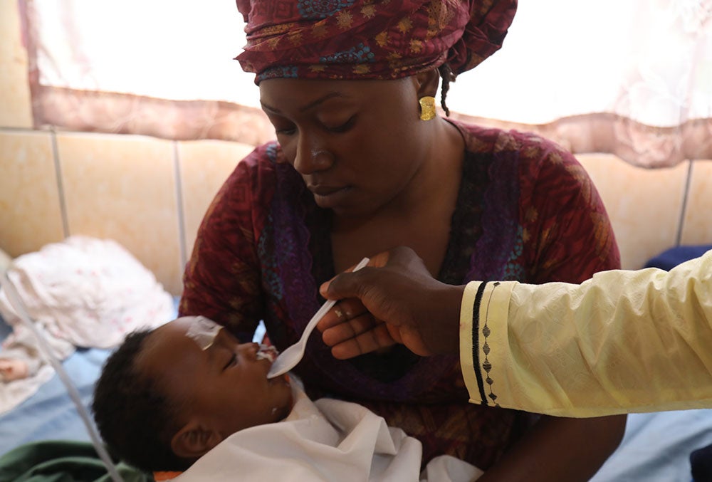 Rafiatou feeding Mouhamed after his cleft surgery