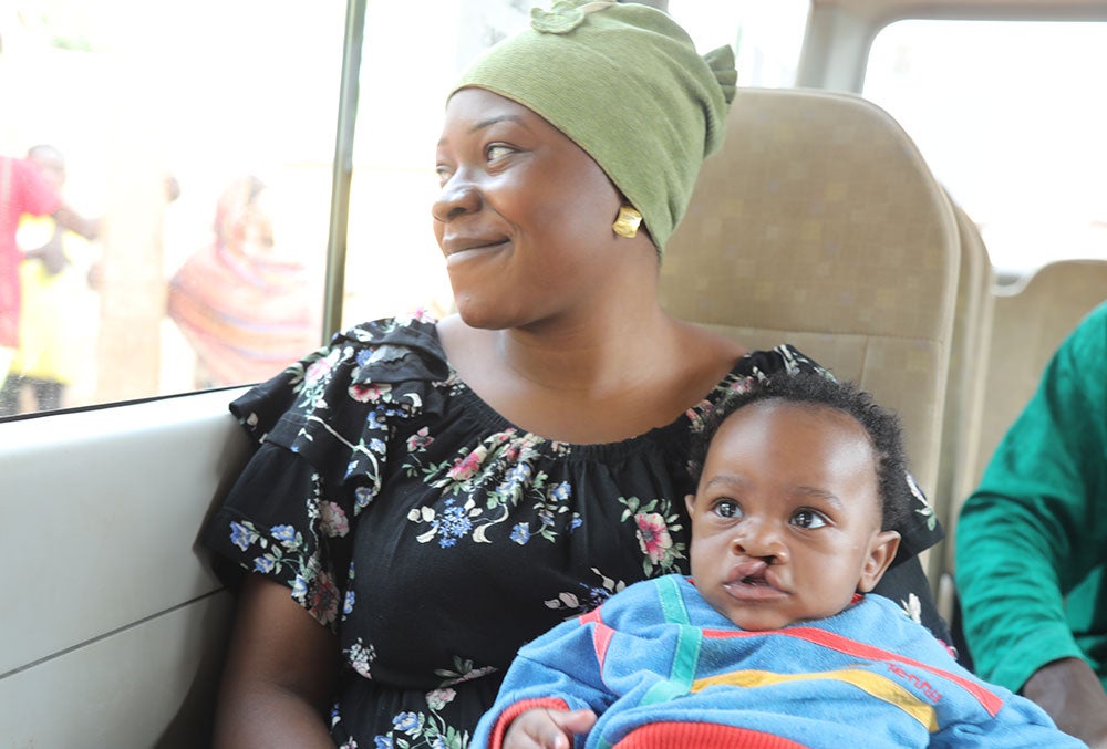 Mouhamed with his smiling mother Rafiatou in a car