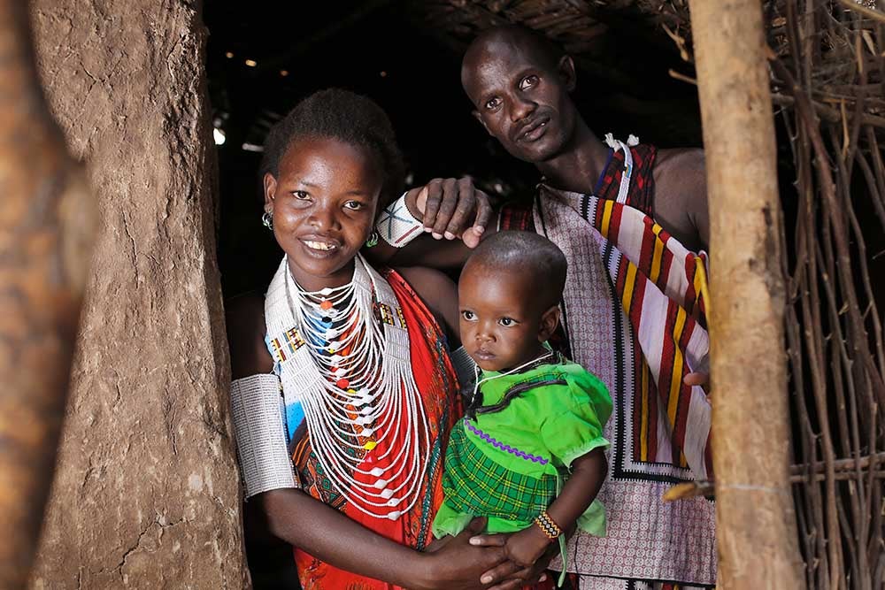 Ndindai smiling and holding her baby after cleft surgery