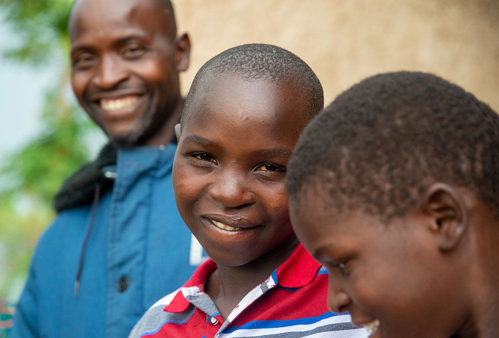 Osawa smiling with his father and friend after cleft surgery