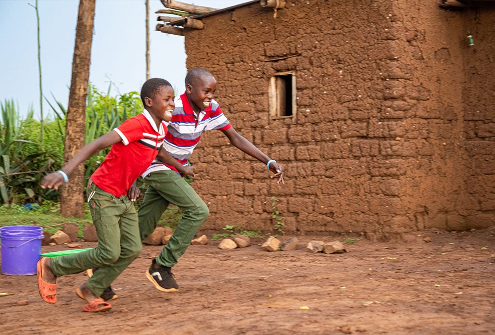 Osawa smiling and running with his friend