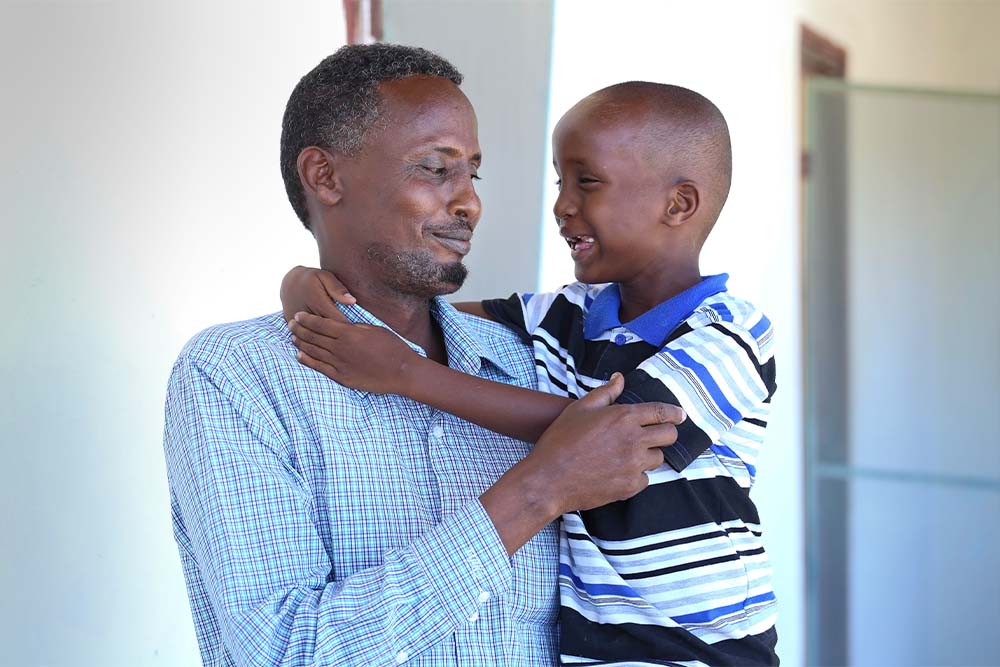 Shariif smiling with his father Mohammed after cleft surgery