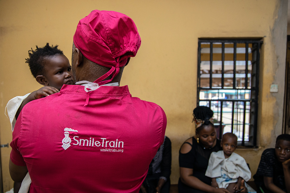 Smile Train partner holding a cleft-affected patient