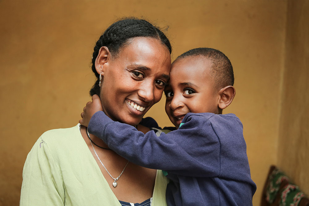 Yohanes smiling and hugging his mother Atsede after cleft surgery