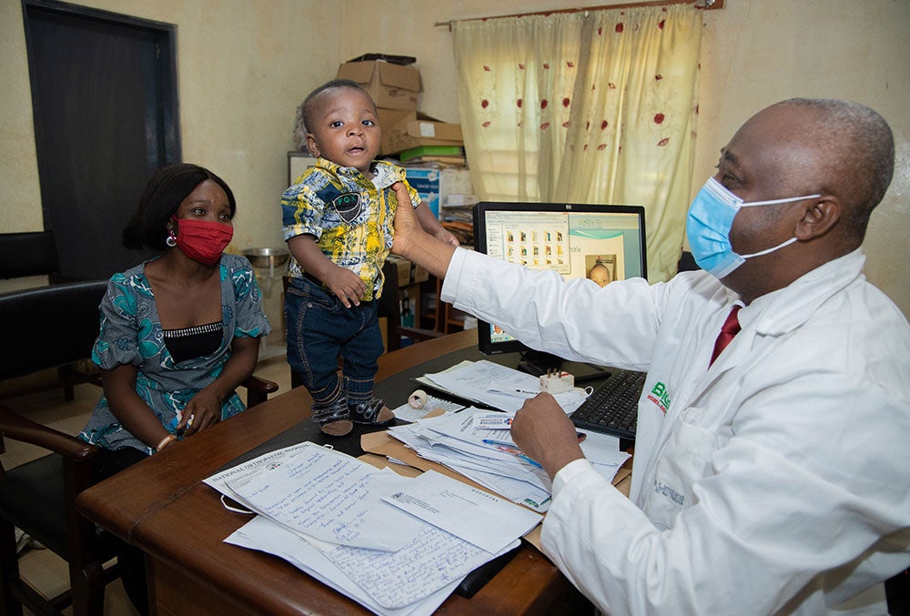 Annointed standing on a table and getting examined by Dr. Ifeanyichukwi Igwilo Onah