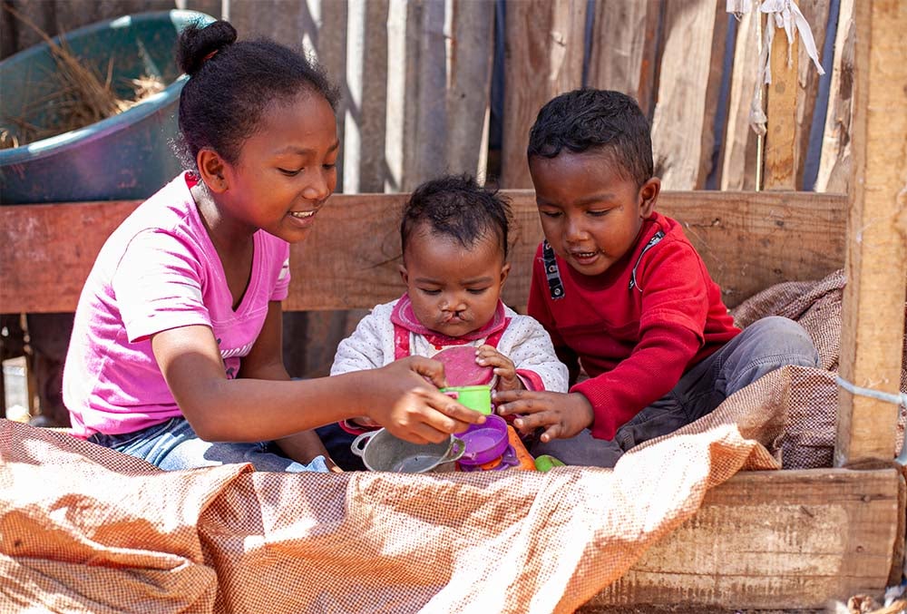 Tsiorihasina before cleft surgery, flanked by her sister and brother