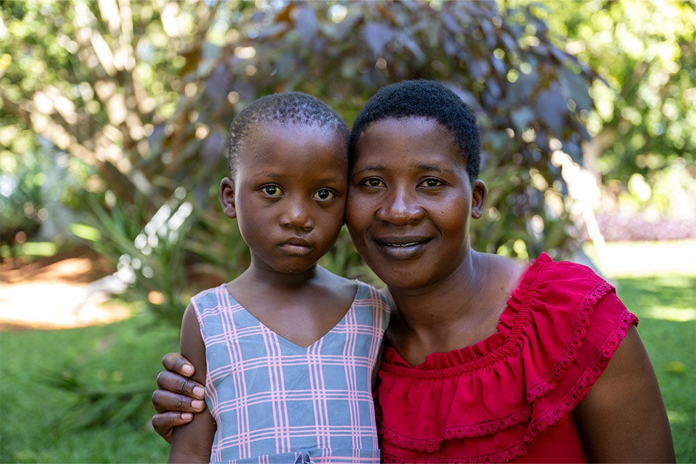 Tracy hugging and smiling with her daughter Rachel after her cleft surgery