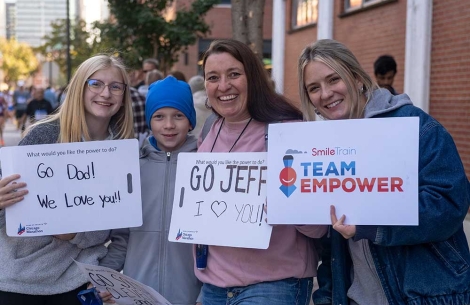 Les supporters de Team Empower sourient et tiennent des pancartes