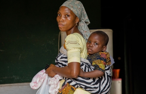 Deborah carrying Opeyemi on her back before his cleft surgery