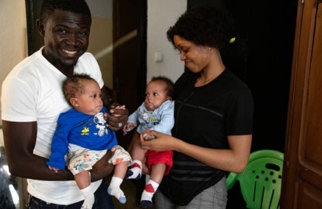 Hervé and Audrey smiling and holding Lloyd and Floyd before their cleft surgeries