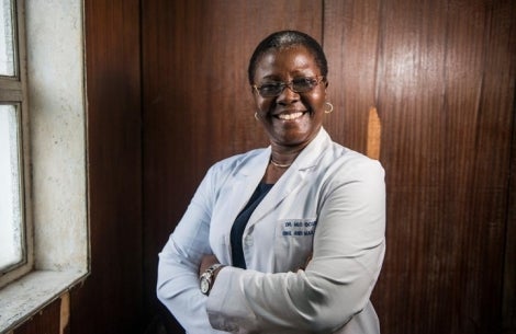 Professor Olugbemiga Ogunlewe smiling with her arms crossed