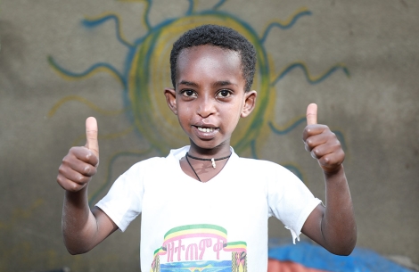 Boy from Ethiopia gives two thumbs up