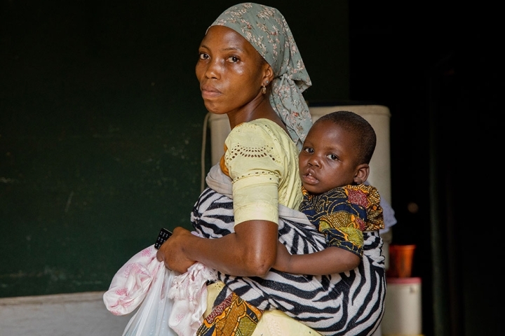 Deborah carrying Opeyemi on her back before his cleft surgery