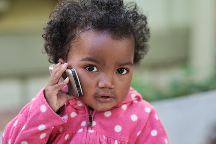 Girl holds cellphone to ear