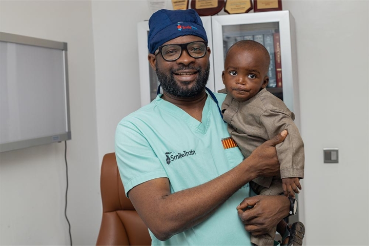 Smile Train doctor holds cleft patient