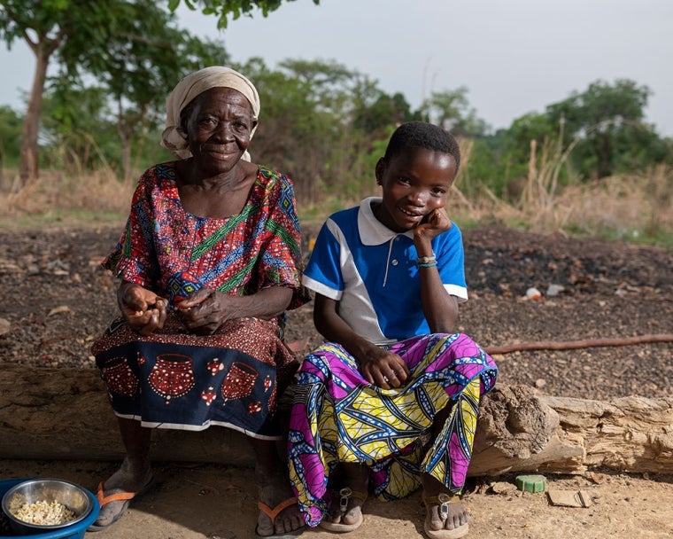 Akuya smiling with her grandmother after cleft surgery