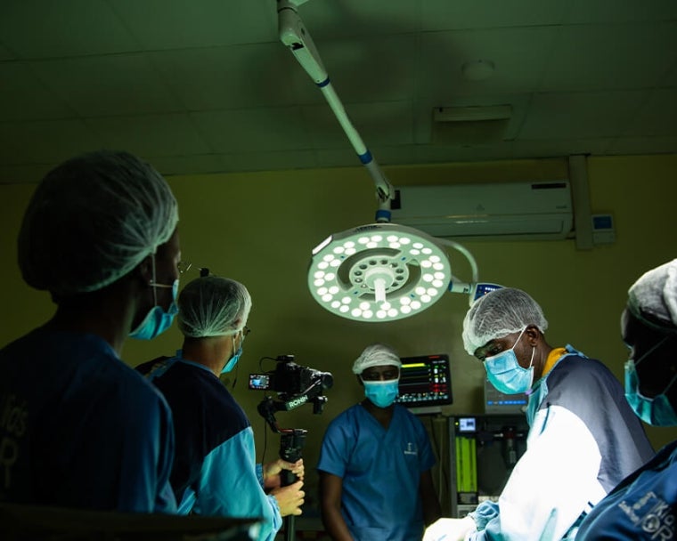 Surgeons performing surgery on cleft patient