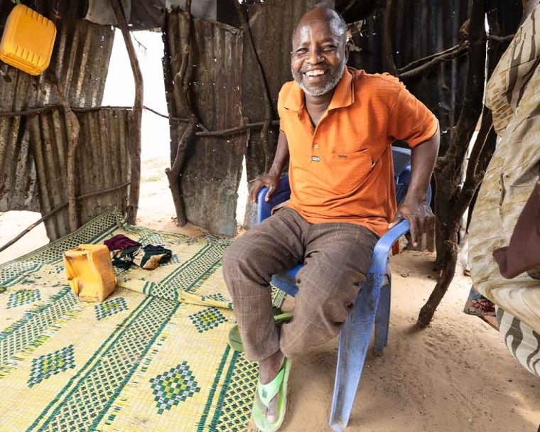 Adan smiling and sitting in a chair after cleft surgery