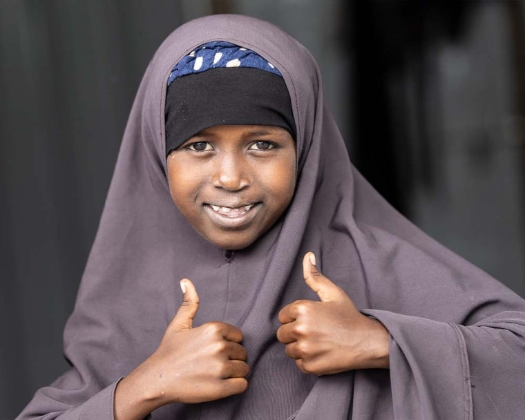 Nasro smiling and giving a thumbs up after cleft surgery