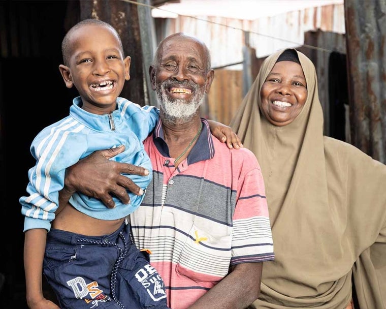 Omar smiling and hugging his parents after cleft surgery